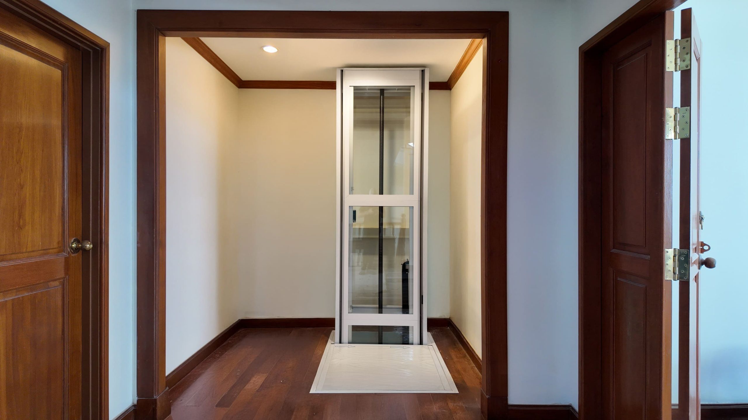 White Ascenda home elevator installed in a home hallway